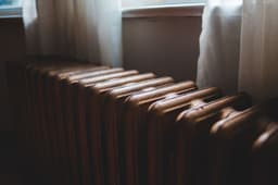 A cast-iron radiator beneath a window