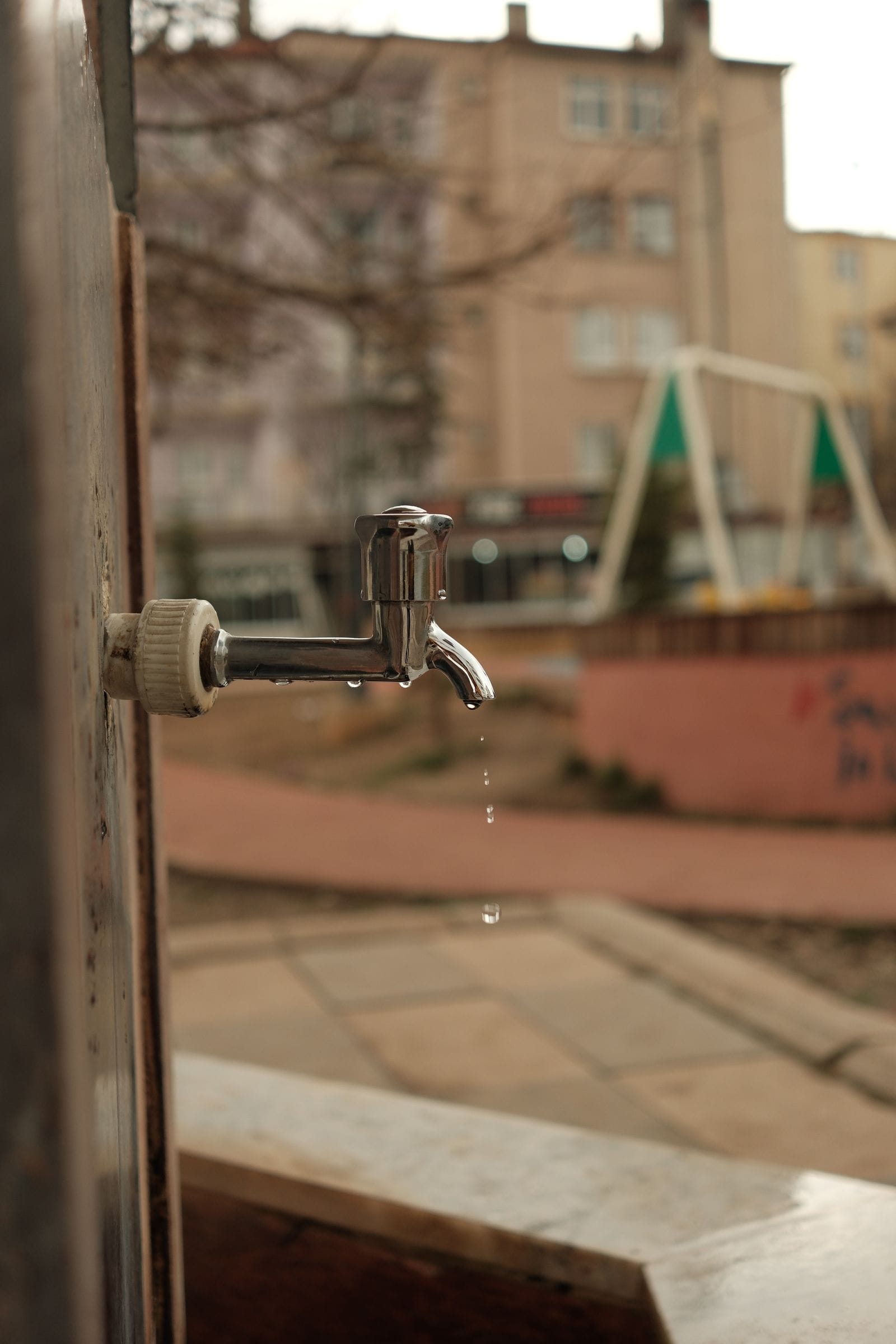 A chrome tap dripping water