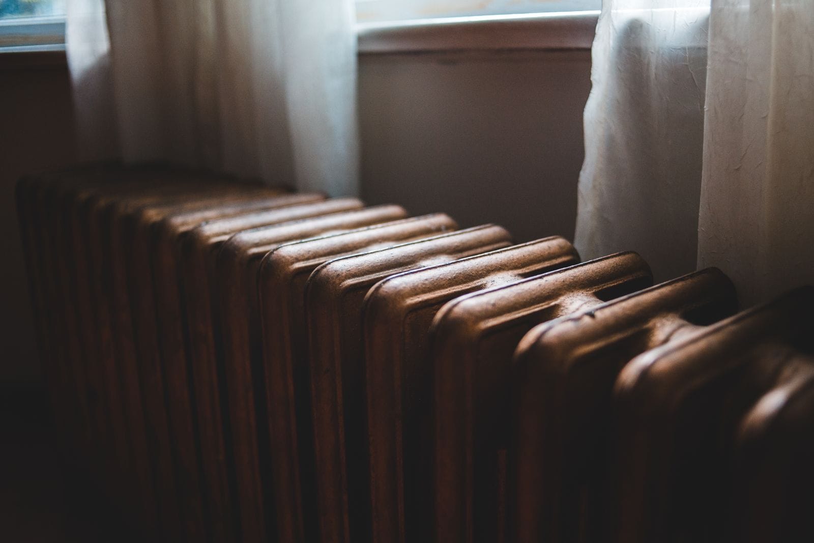 A cast-iron radiator beneath a window