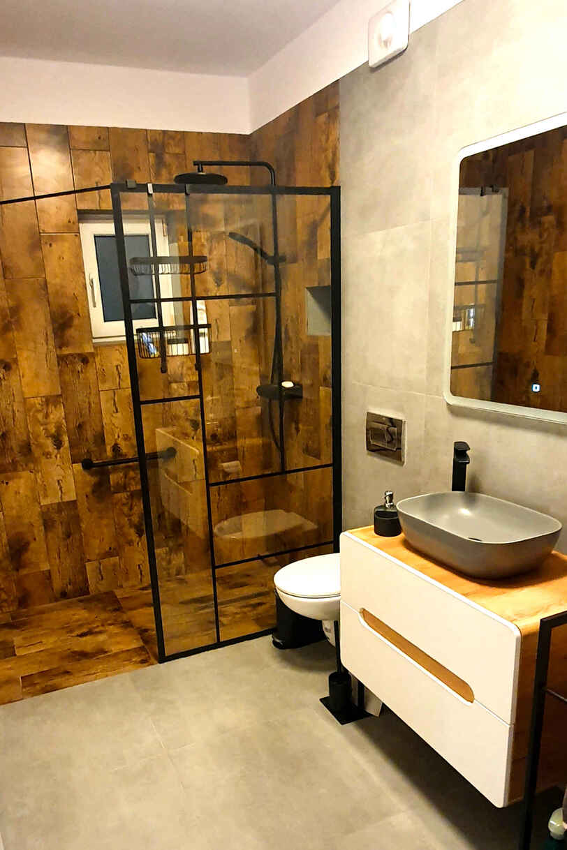 A completed Pimlico bathroom with timber tile and black fittings