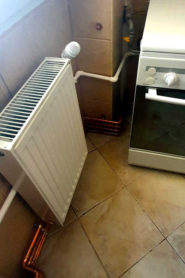 Panel radiator and its connected pipework